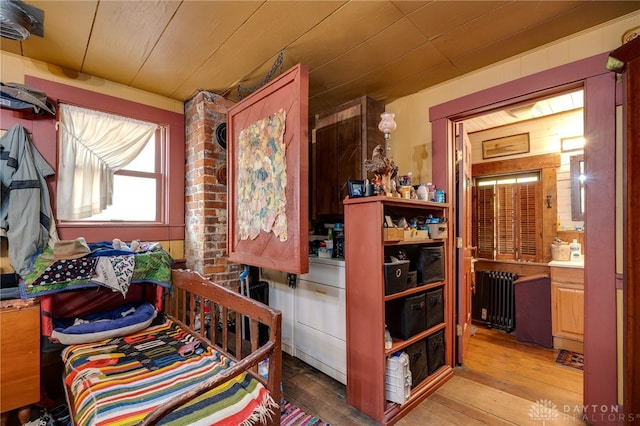 interior space with wood-type flooring, radiator, and wooden ceiling