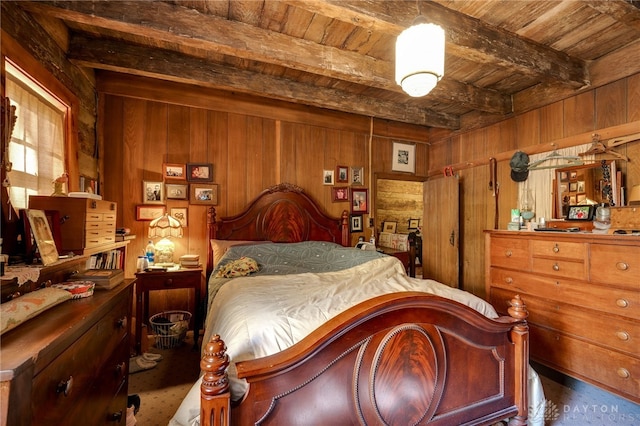 bedroom featuring beamed ceiling, wood ceiling, and wood walls