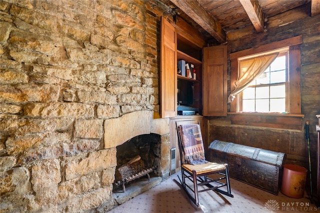 living area with beamed ceiling and wooden ceiling