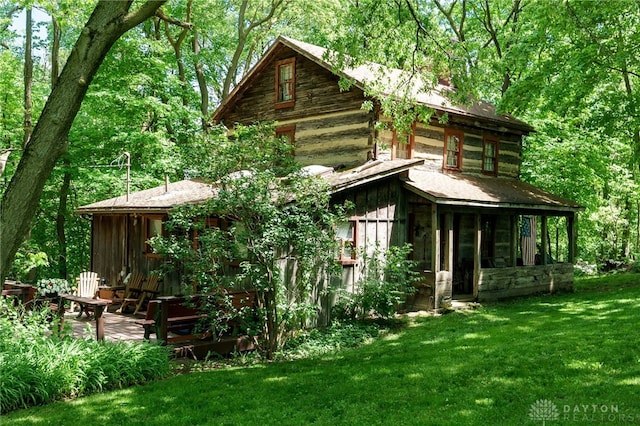 exterior space featuring a yard and a sunroom