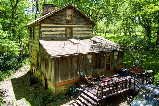 back of house with cooling unit and a deck