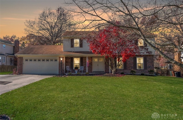 view of front of property featuring a garage and a yard