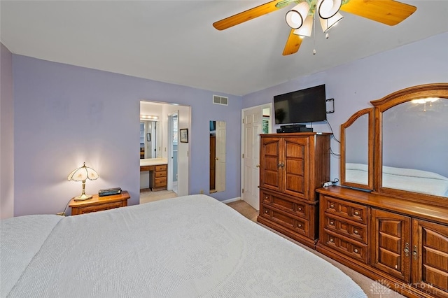 carpeted bedroom with connected bathroom and ceiling fan