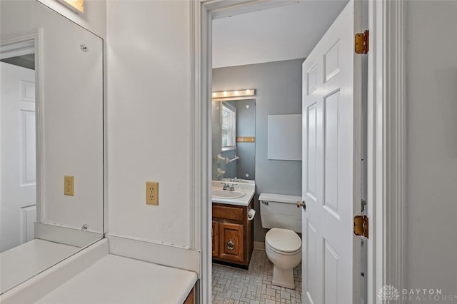 bathroom featuring vanity, tile patterned floors, and toilet