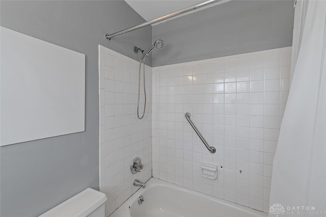 bathroom featuring toilet and shower / bathtub combination with curtain