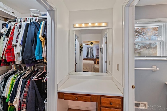 spacious closet with ceiling fan