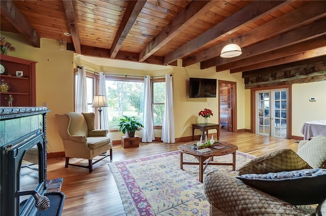 sitting room with beamed ceiling, wooden ceiling, and light wood-type flooring