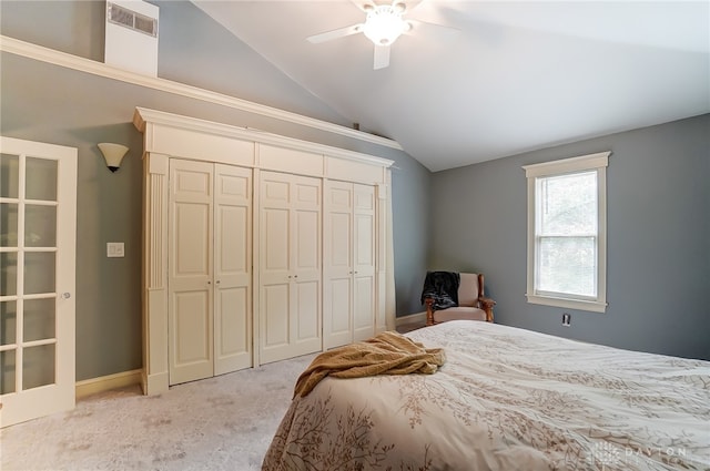 bedroom with a closet, ceiling fan, vaulted ceiling, and light colored carpet