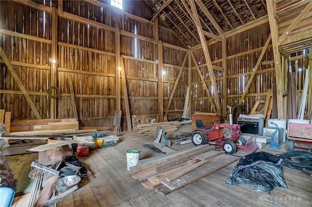 misc room with wood-type flooring and vaulted ceiling