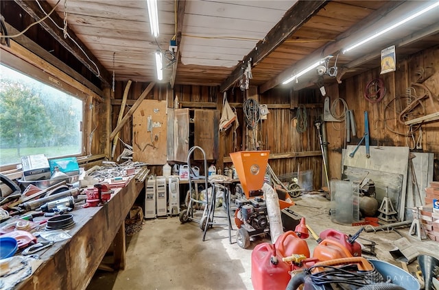 miscellaneous room featuring wood ceiling, wooden walls, and a workshop area