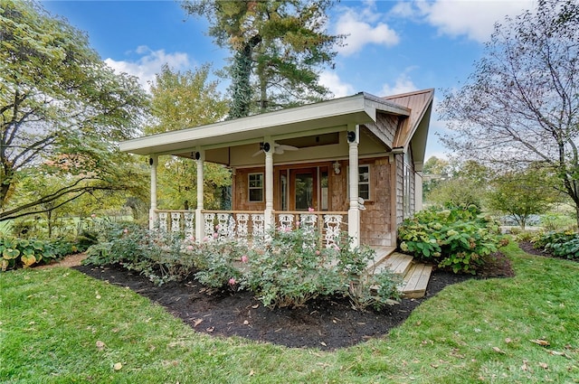 exterior space featuring a yard and ceiling fan