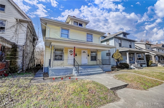 view of front facade with covered porch and a front yard