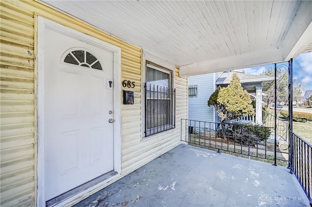 view of exterior entry with a porch