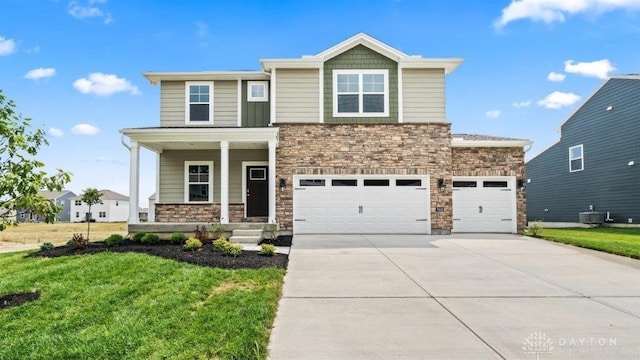 view of front of property featuring a front lawn, a porch, and a garage