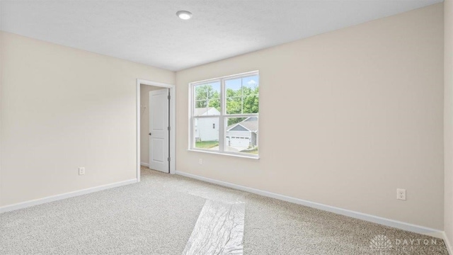 unfurnished room with light colored carpet