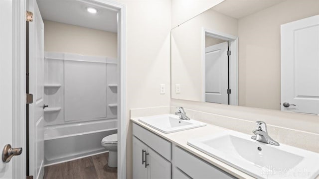 full bathroom with bathtub / shower combination, hardwood / wood-style floors, vanity, and toilet