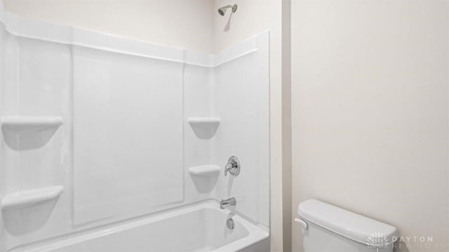 bathroom featuring shower / tub combination and toilet