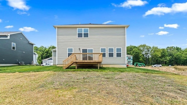 back of property featuring a yard, central AC unit, and a deck