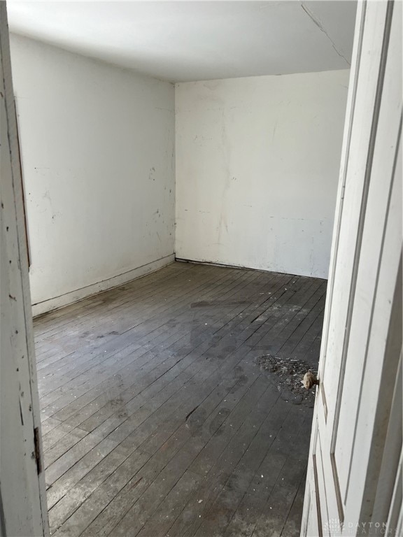 spare room featuring dark wood-type flooring