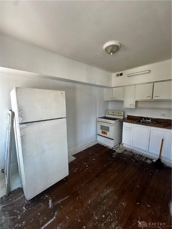 kitchen with white cabinets, sink, white appliances, and dark wood-type flooring