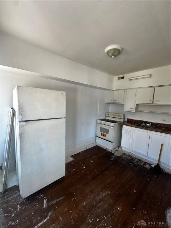 kitchen featuring white cabinets, white appliances, dark hardwood / wood-style floors, and sink