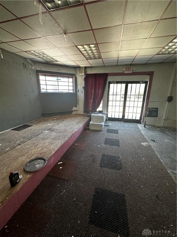 miscellaneous room with a wealth of natural light and a drop ceiling