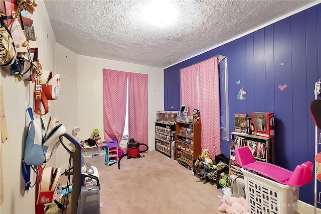 playroom featuring carpet and a textured ceiling