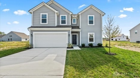 view of front facade with a garage and a front lawn