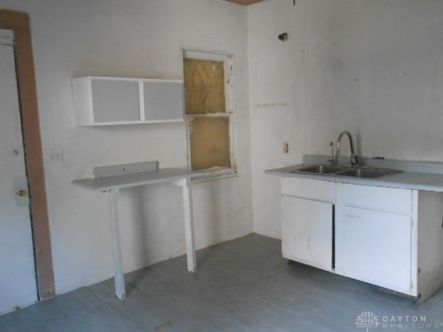 kitchen featuring dark hardwood / wood-style floors, white cabinetry, and sink