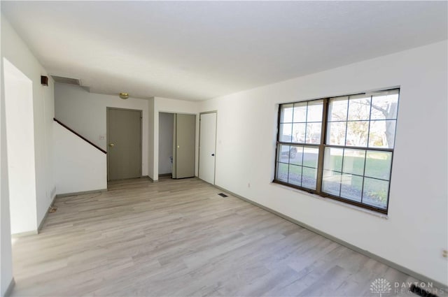 spare room featuring light hardwood / wood-style floors