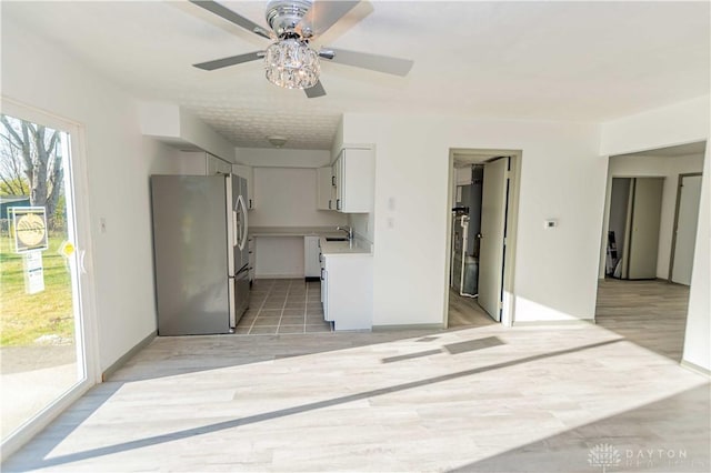 unfurnished room featuring sink and light hardwood / wood-style floors