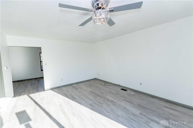 empty room with ceiling fan and light wood-type flooring