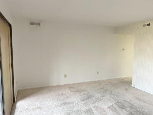 empty room with light colored carpet