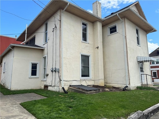 rear view of property with a lawn