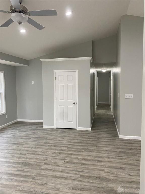 spare room with ceiling fan, light hardwood / wood-style floors, and lofted ceiling