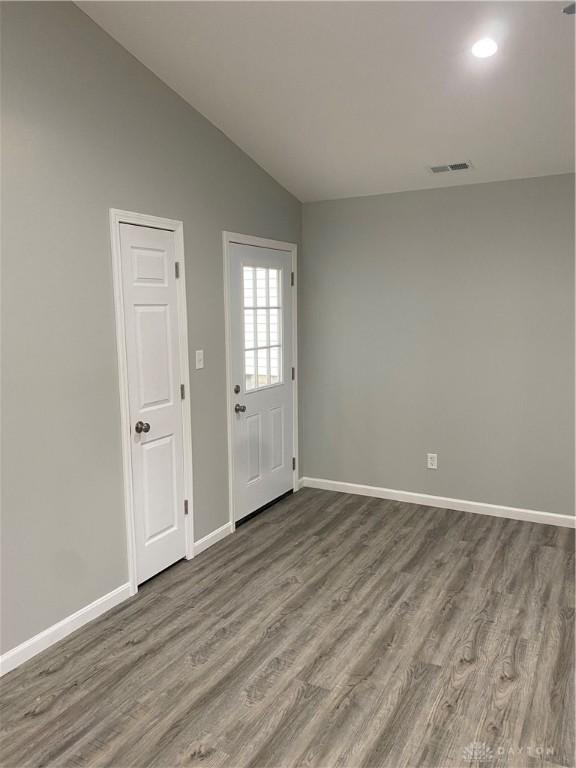 interior space with hardwood / wood-style floors and lofted ceiling