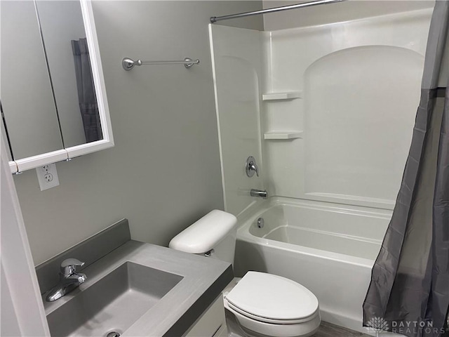 full bathroom with shower / bath combo, vanity, and toilet