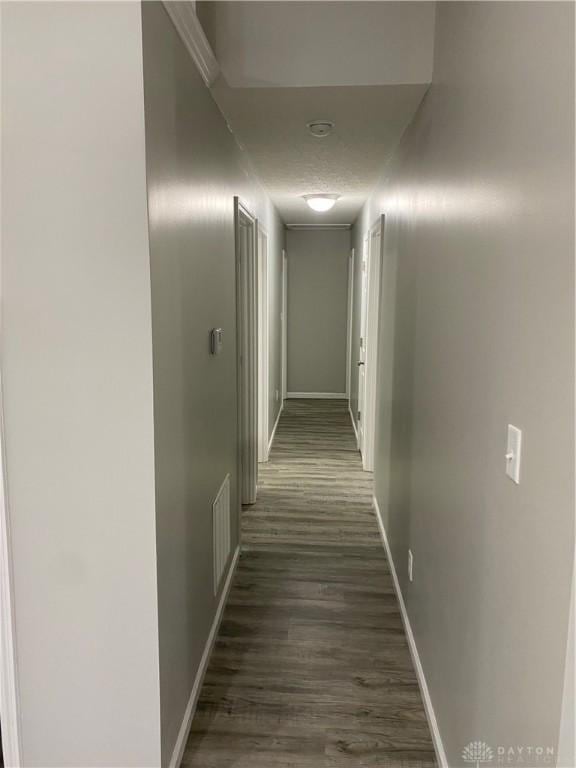 hallway with dark hardwood / wood-style floors