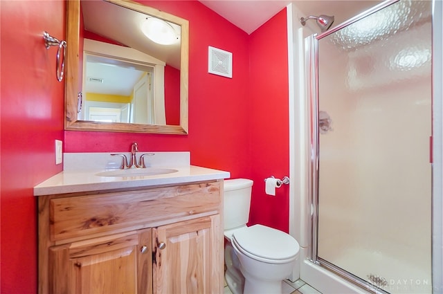 bathroom with vanity, a shower with door, tile patterned flooring, and toilet