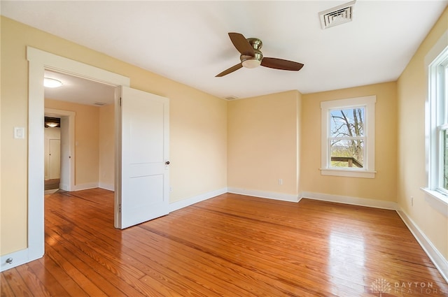 spare room with hardwood / wood-style flooring and ceiling fan