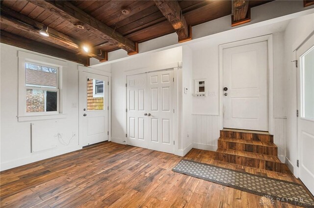 entryway featuring beamed ceiling, hardwood / wood-style floors, and wooden ceiling