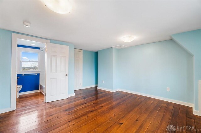 unfurnished bedroom featuring dark hardwood / wood-style flooring