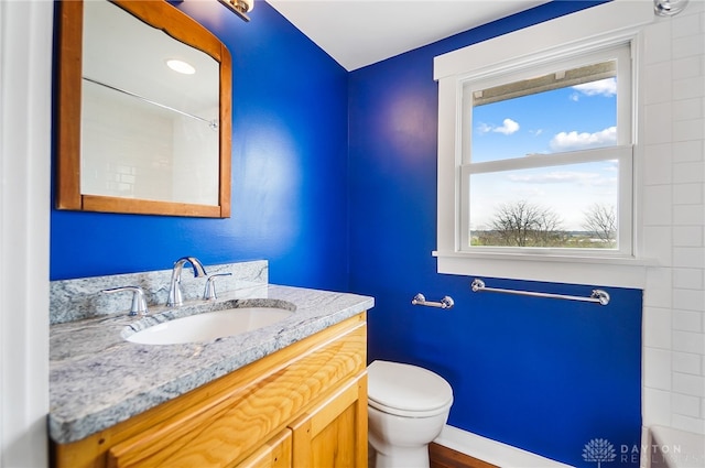 bathroom featuring vanity and toilet