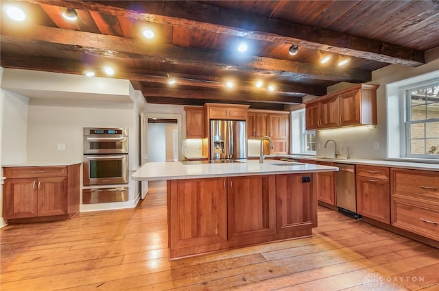 kitchen featuring a kitchen island with sink, wood ceiling, stainless steel appliances, beamed ceiling, and light hardwood / wood-style floors