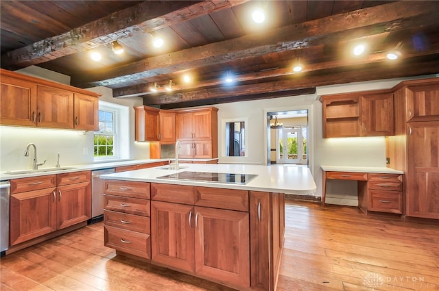 kitchen featuring wood ceiling, an island with sink, beamed ceiling, light hardwood / wood-style floors, and sink