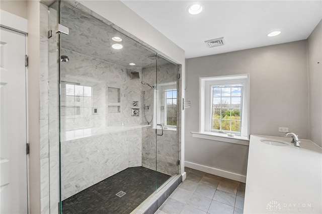 bathroom with sink, tile patterned floors, and an enclosed shower