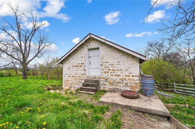 exterior space featuring an outbuilding and an outdoor fire pit