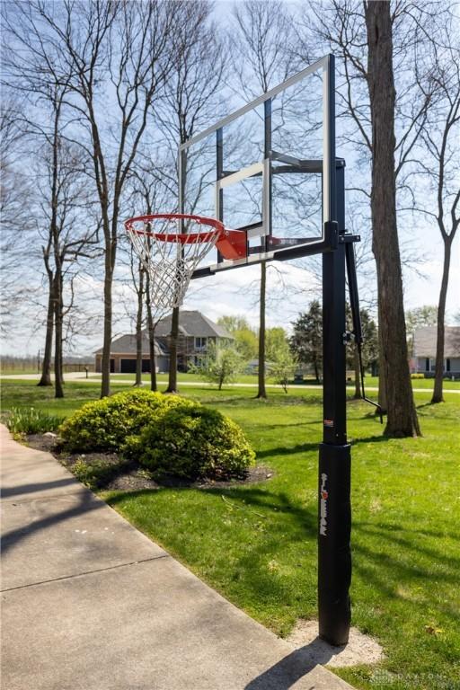 view of basketball court with a yard