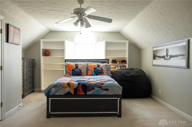 bedroom with vaulted ceiling, a textured ceiling, light colored carpet, and ceiling fan