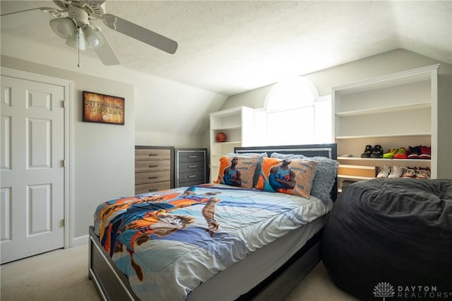 carpeted bedroom with ceiling fan and lofted ceiling